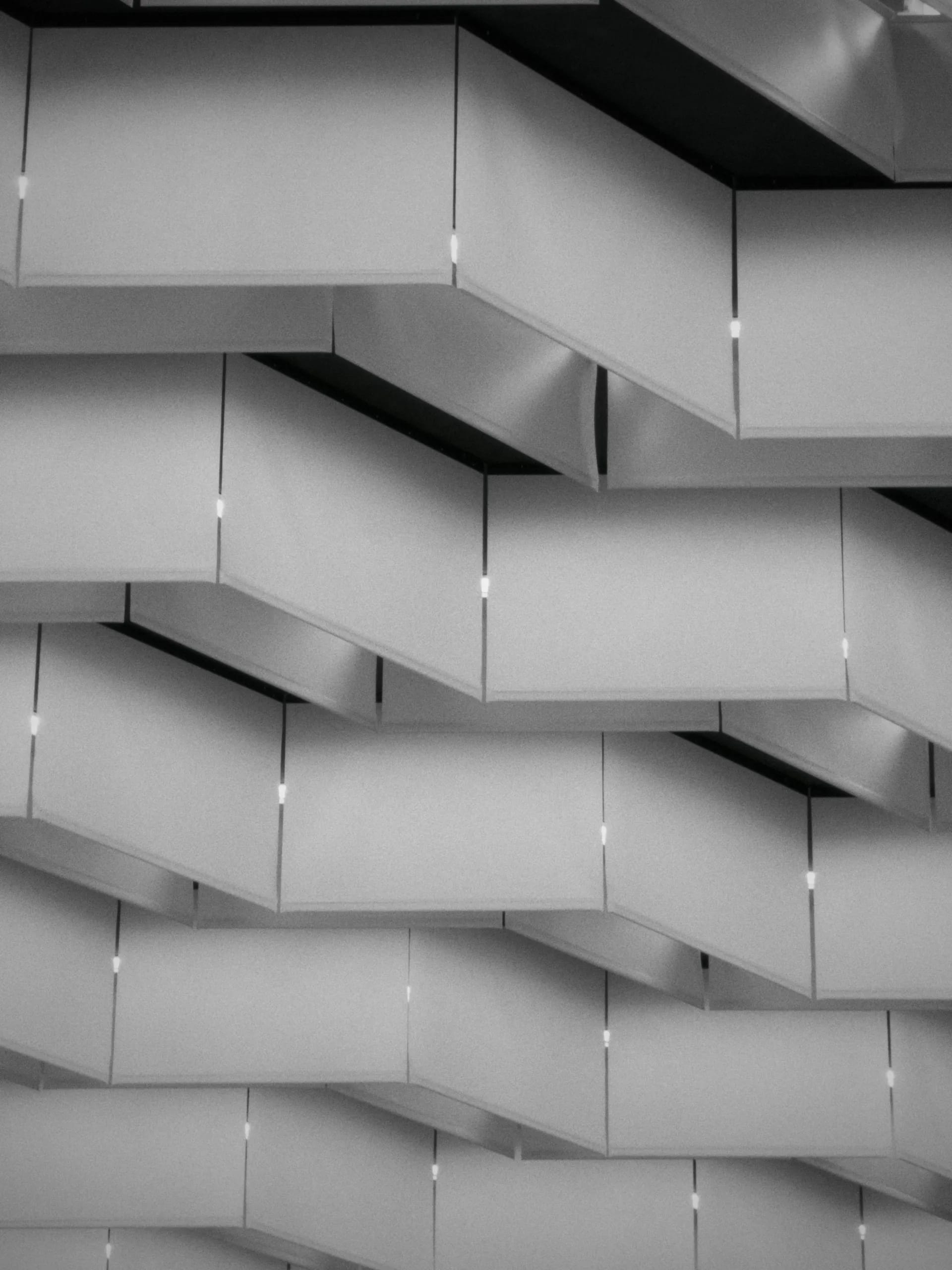 A black and white architectural pattern of stacked geometric panels.